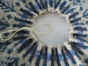Plate inserted convex side towards the top of the tam, and cotton 4ply run through the welt to gather and pull gently